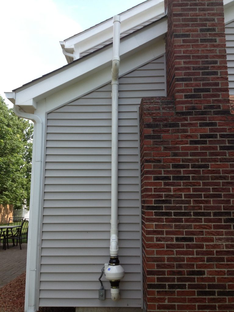 Exterior radon mitigation fan installed on Columbus Ohio residential property