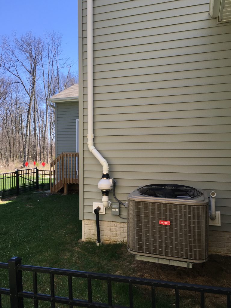 Radon mitigation fan venting harmful gases safely above the roofline