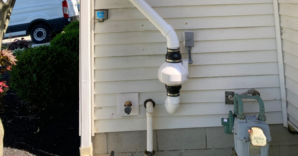 radon fan installed on the exterior wall of a residential home in columbus ohio