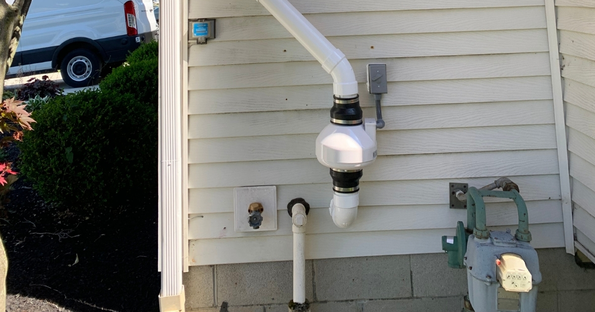 radon fan installed on the exterior wall of a residential home in columbus ohio